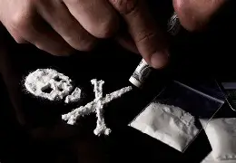buy cocaine online usa, in this photo cocaine has been used to design a bone scale on a table with a finger holding a straw to consume it and one can clearly see cocaine in small white plastic bags